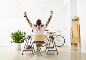 Tattooed,Lucky,Freelancer,In,Front,Of,His,Working,Space,,Surrounded